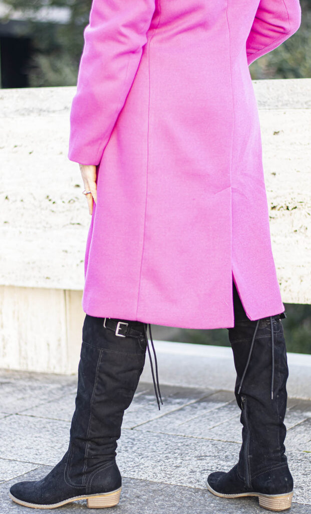 Black boots and pink winter coat