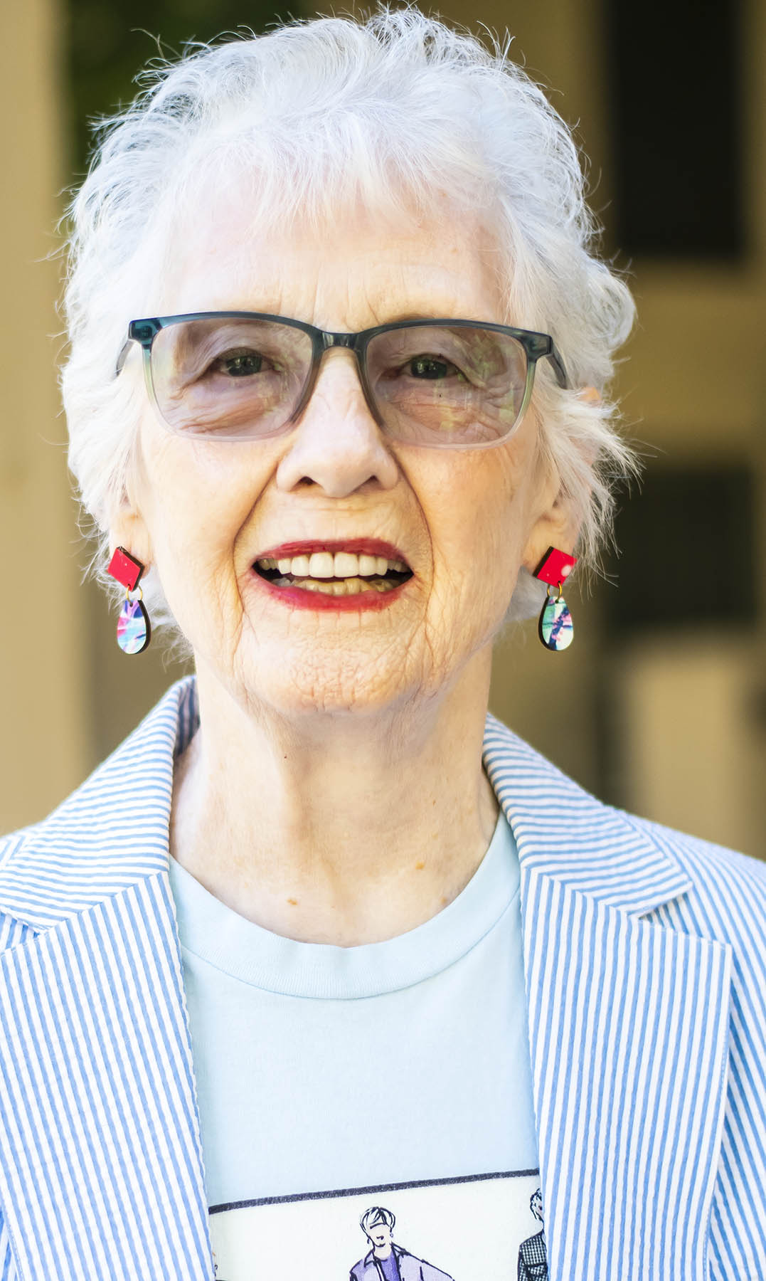 Woman in 80's wearing whimsical earrings